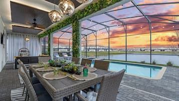 Enjoy al fresco dining with a view of the pool and serene surroundings.