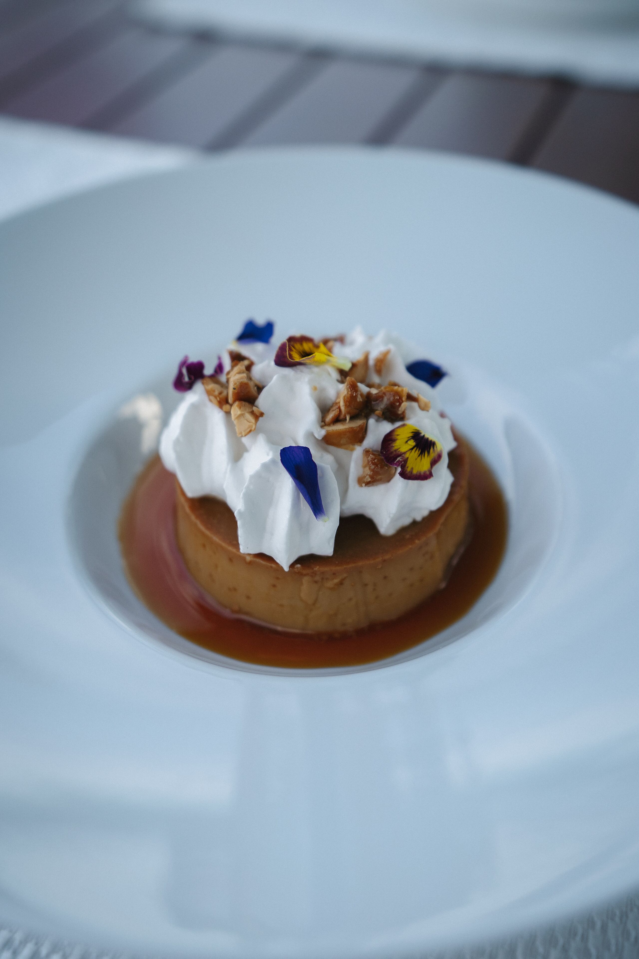 A dessert on a white plate with a caramel sauce.