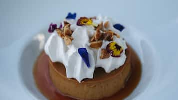 A dessert on a white plate with a caramel sauce.