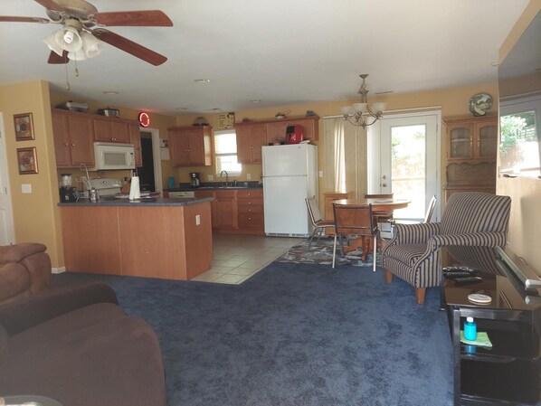 A compact living space with a kitchen, dining area, and seating.