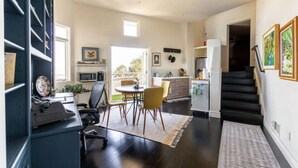 Una cocina moderna con comedor, una escalera y vistas al exterior.