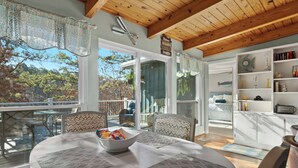 A cozy room with a dining table, chairs, and a view of the outdoors. - Lakefront Home w/ Dock: 10 Mi to Central Ave! (Hot Springs)