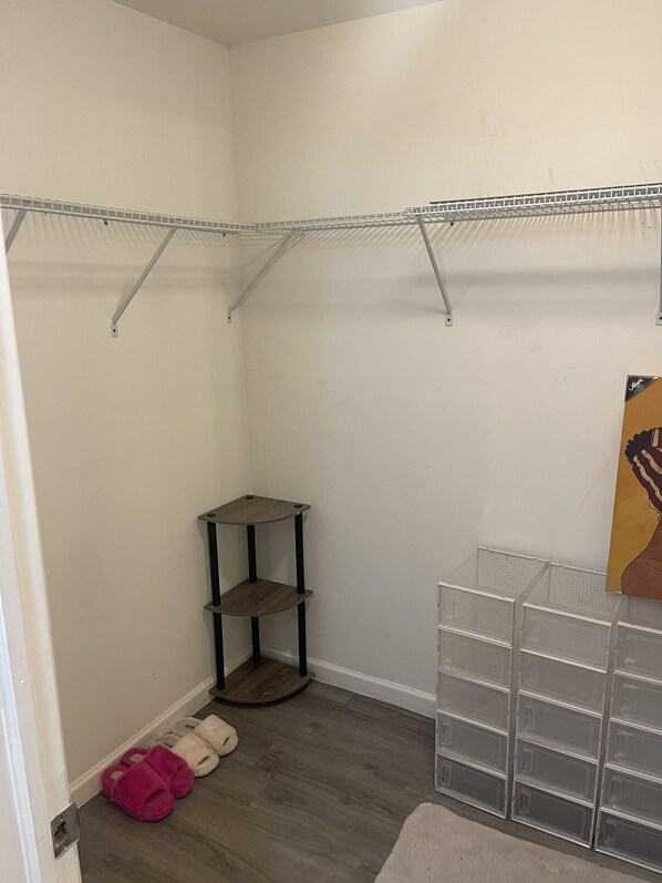 A walk-in closet with metal shelving, a shoe rack, and storage drawers. - GORGEOUS 1/1 CONDO (Lauderdale Lakes)