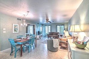 Relax in this inviting living area with a dining table, sofa, and coffee table.