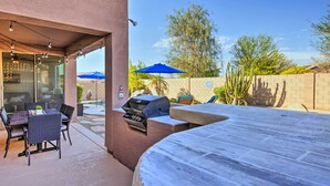 An outdoor patio with a grill, dining table, and chairs. - Hike & Golf: Goodyear Retreat w/ Patio + Fire Pit! (Goodyear)