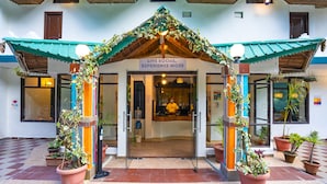 A building entrance with a sign reading "LIVE SOCIAL. EXPERIENCE MORE".