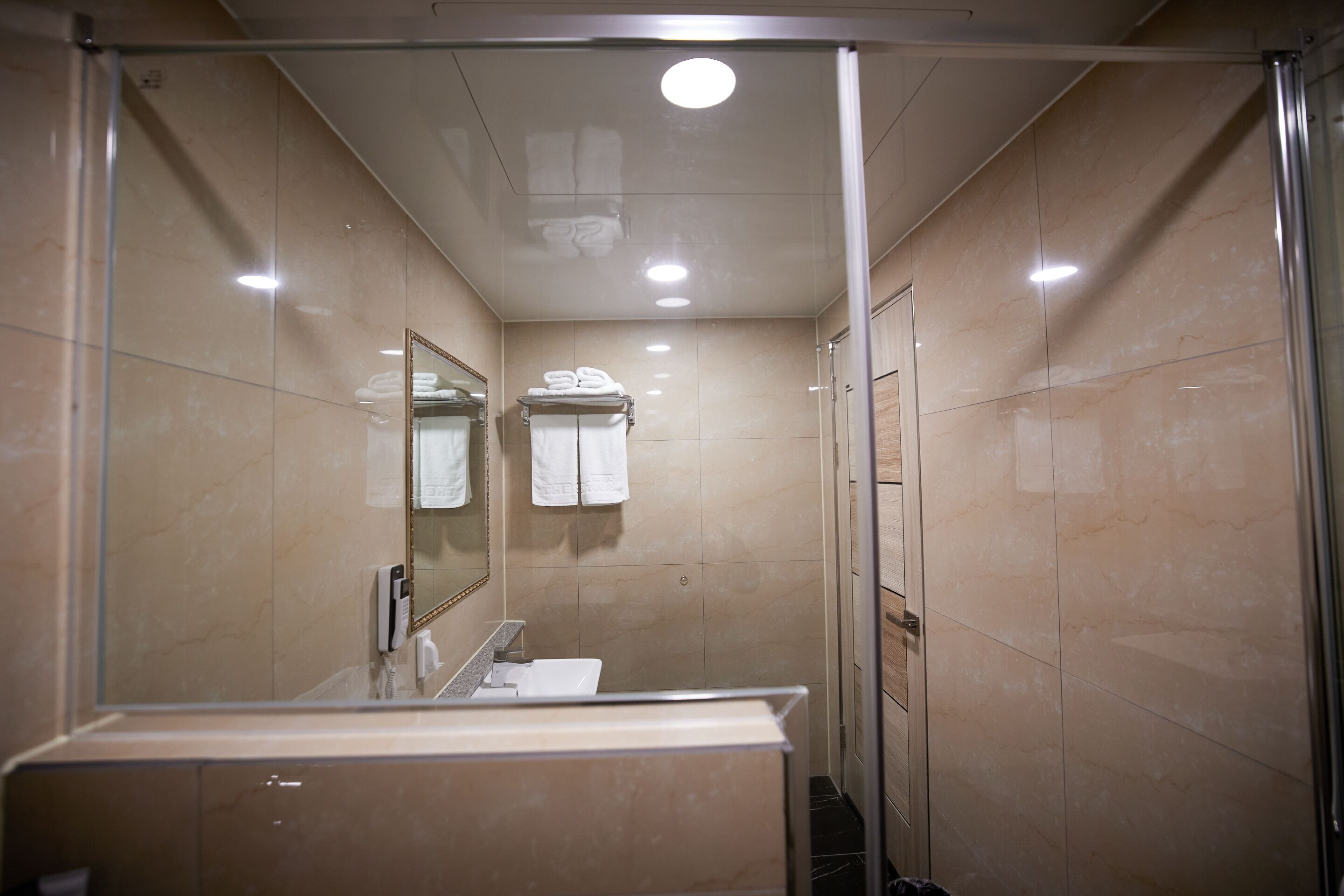 corner suite | bathroom | shower, hair dryer, bathrobes, slippers