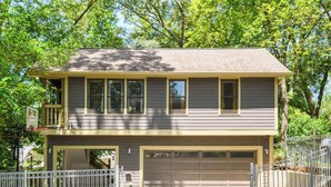 A two-story house with a garage, a fenced yard, and a basketball hoop. - Treefort (Atlanta)