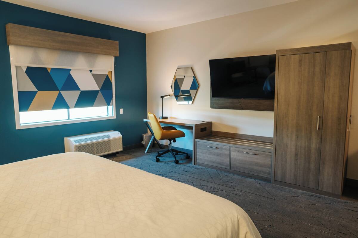 Desk, laptop workspace, bed sheets
