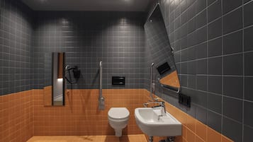 Un baño con inodoro, lavamanos y ducha.