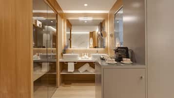 A modern bathroom with wooden paneling, two sinks, a mirror, and a cabinet.