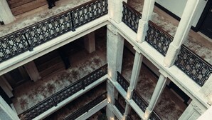 A multi-level atrium with a central staircase, columns, and seating areas. - Mest Hotel Istanbul Sirkeci (Istanbul)