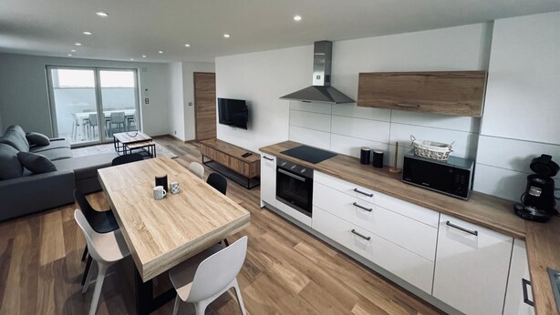A modern kitchen with white cabinets, a wooden countertop, and a built-in oven. - RANDOM LISTING (Wintzenheim)