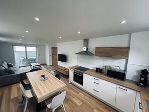 A modern kitchen with white cabinets, a wooden countertop, and a built-in oven. - RANDOM LISTING (Wintzenheim)