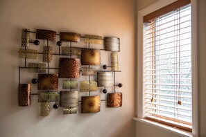 A wall with a grid of square and rectangular decorative panels, some with circular elements, against a plain wall. - 4br-7guests-freeparking-garden-wifi (Derby)