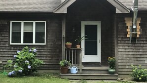 A house with a front porch, a door, and a small window. - Centrally located in OakBluffs on Martha’s Vineyard (Oak Bluffs)