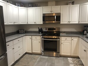 Microwave, dishwasher, coffee/tea maker, cookware/dishes/utensils