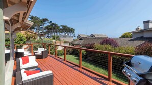 A deck with wicker furniture and a grill. - Shell's Treasure: Fully Updated Three bedroom home with Ocean Views (Pacific Grove)