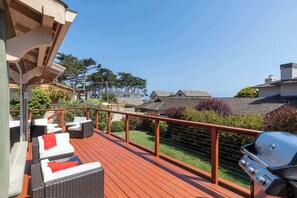 A deck with wicker furniture and a grill. - Shell's Treasure: Fully Updated Three bedroom home with Ocean Views (Pacific Grove)
