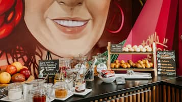 A breakfast buffet with various food items and condiments.