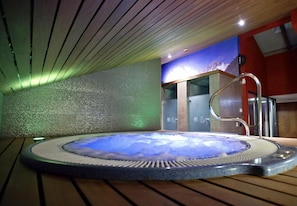 Relax in our serene spa area, featuring a hot tub and tranquil atmosphere.