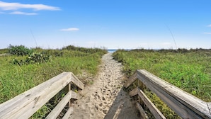 A sandy beach path with wooden railings on either side, leading towards the sea. - Xanadu II 605-3BR/3BA Oceanfront condo in Cherry Grove (North Myrtle Beach)