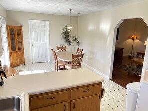 Cozy living space with a kitchen area, dining table, and comfortable seating.