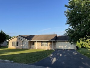 Stroll up to this charming home, featuring a well-manicured lawn and a convenient garage.