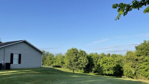 A house with a sloped roof and a front yard with a well-maintained lawn. - Matthew Estates Ranch (Dandridge)