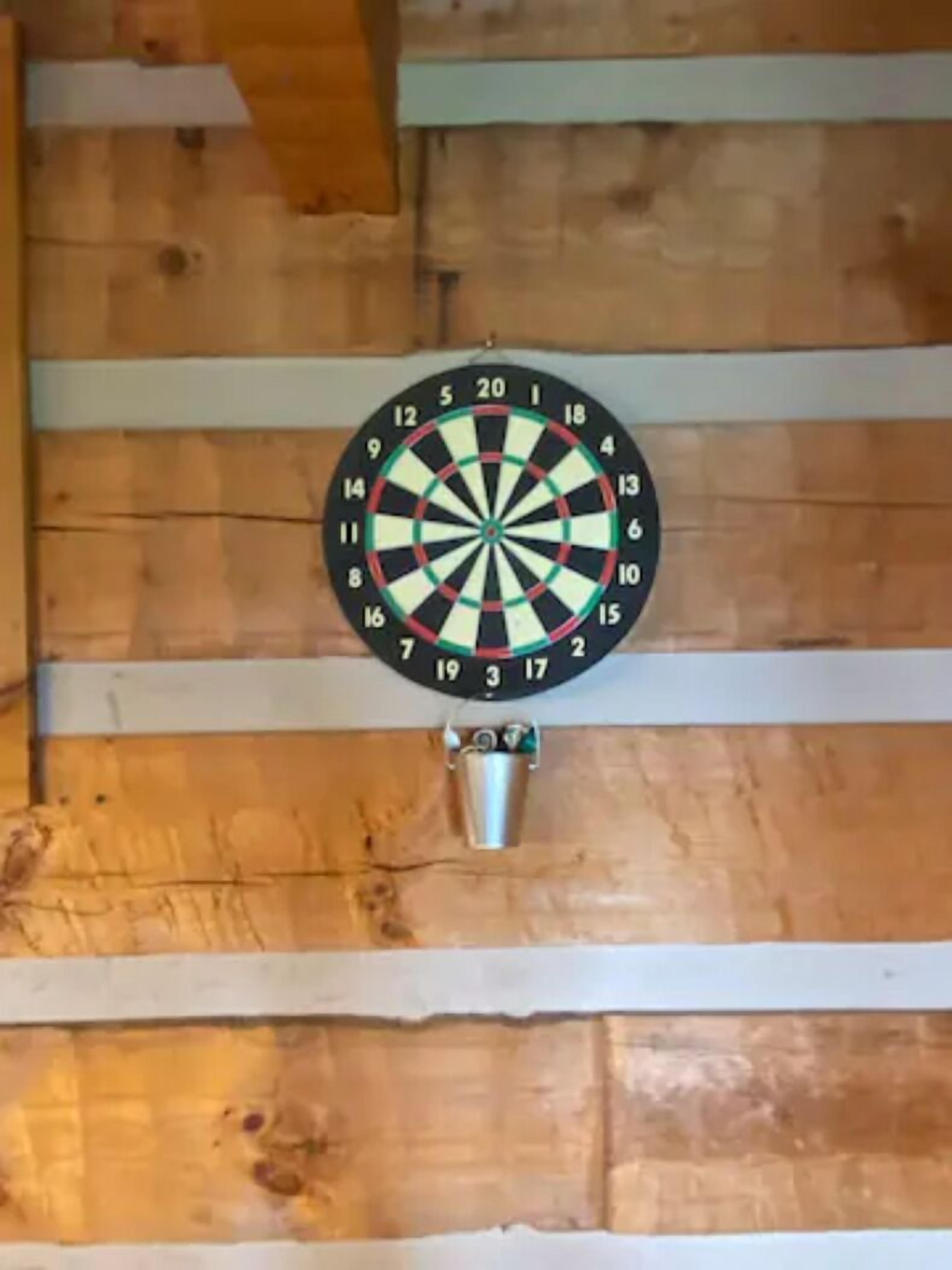 A dartboard mounted on a wooden wall.