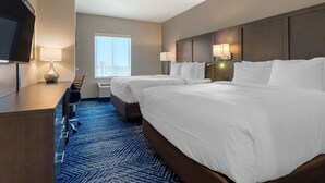 A hotel room with two beds, a desk, a TV, and a window with a city view. - Comfort Inn & Suites Balch Springs - SE Dallas (Mesquite)