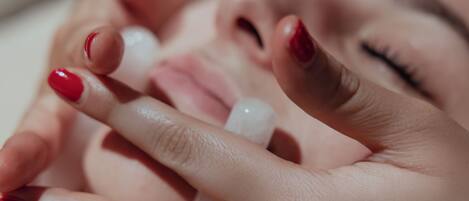 A close-up of hands with red nail polish.