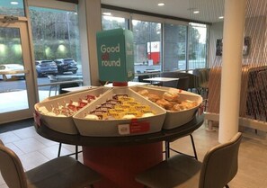 A breakfast buffet with various food items and a 'Good all round' sign. - avid hotel Salem by IHG (Salem)