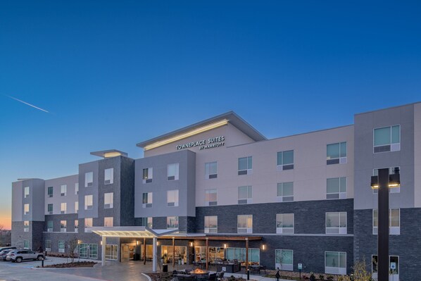 A modern hotel with a sign reading "TOWNPLACE SUITES BY MARRIOTT" and a covered outdoor seating area. - TownePlace Suites by Marriott Dallas Rockwall (Rockwall)