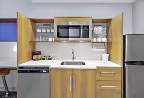 A compact kitchen with a microwave, sink, and refrigerator. - Home2 Suites by Hilton Whitestown Indianapolis NW (Whitestown)