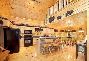 Enjoy cooking in this well-equipped kitchen with a central island, sink, and stove, perfect for preparing meals.