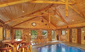 A wooden cabin with a pool, stone walls, and wooden furniture. - 3 bed/3 bath luxury cabin with it's own private heated salt water pool! (Sevierville)