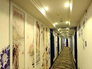 Stroll through a traditional corridor with floral and abstract designs adorning the walls.