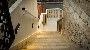 A staircase with stone walls and a white railing, leading to a balcony. - Apartments Tayra - Comfort Studio with Balcony (BR3) (Dubrovnik)