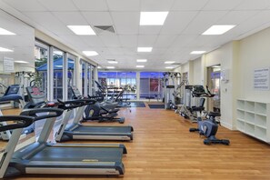 A gym with treadmills, stationary bikes, and weight machines.