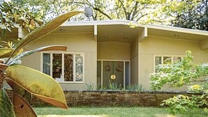 A single-story house with a flat roof, large windows, and a front porch. - Walk to Campus, Minutes to Square: Entire Home w Spacious Yard, Pet-Friendly! (Oxford)