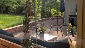 A patio area with a sofa, chairs, and potted plants. - Walk to Campus, Minutes to Square: Entire Home w Spacious Yard, Pet-Friendly! (Oxford)
