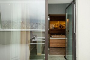 A modern bathroom with a glass shower enclosure, a wooden vanity, and a view of a snowy landscape. - Elexus Poiana Brasov (Brasov)