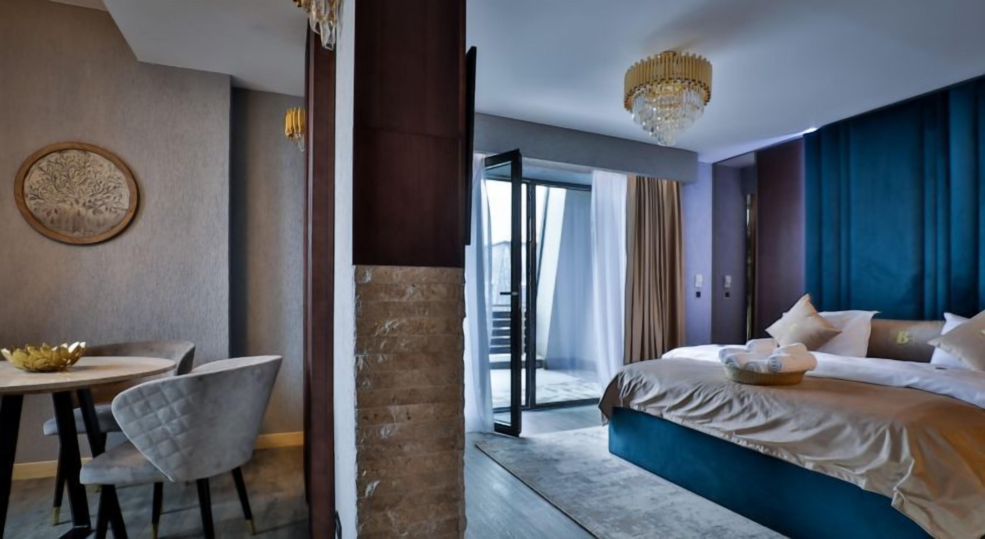 A hotel room with a bed, a desk, and a chair.