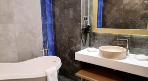 A modern bathroom with a freestanding bathtub, a round sink, and a mirror. - Elexus Poiana Brasov (Brasov)