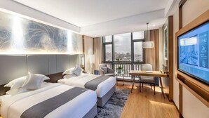A modern hotel room with two beds, a desk, a TV, and a large window with a city view. - Greentree Eastern Suzhou Dushu Lake Guoyuan Road Subway Station Hotel (Suzhou)