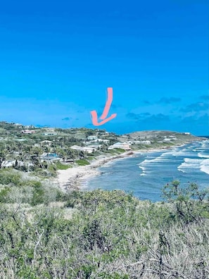 A coastal landscape with houses and a beach.