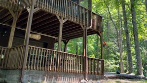 A wooden cabin with a balcony and a covered porch area, surrounded by trees. - Happy mtn. home, enjoy 7 acres & 2 ponds, 1/2 mile to DuPont State Forest gate! (Cedar Mountain)