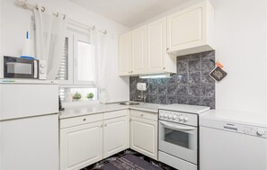 Fridge, stovetop, dishwasher, coffee/tea maker