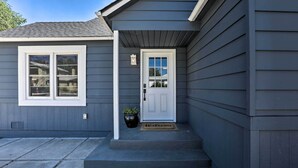 A house with a gray exterior, a white front door, and a welcome mat. - Hot Tub, Fire Pit: Midtown Reno Oasis! (Reno)